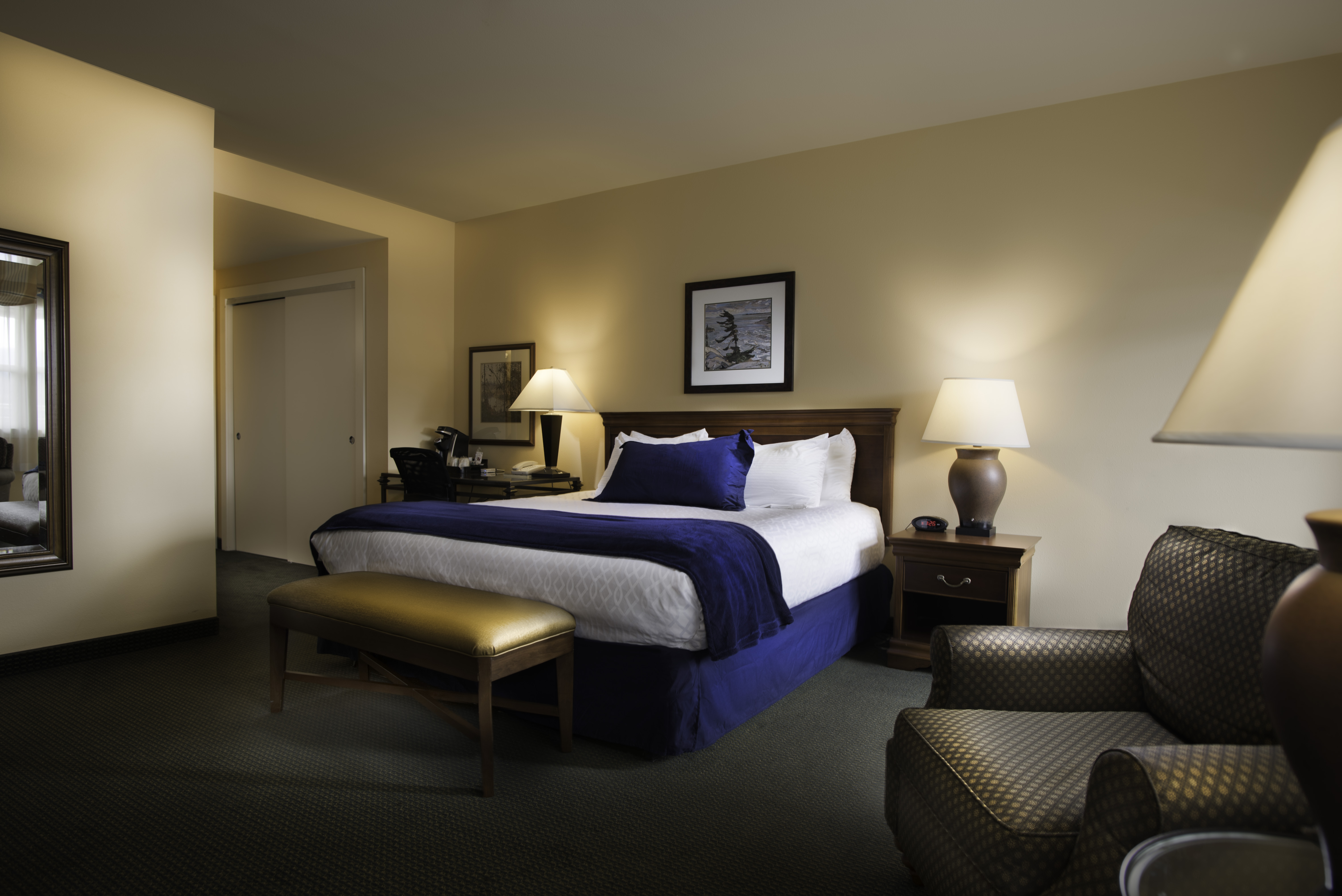 Spacious king room at The Landing Hotel in Ketchikan with warm lighting and comfortable seating area.