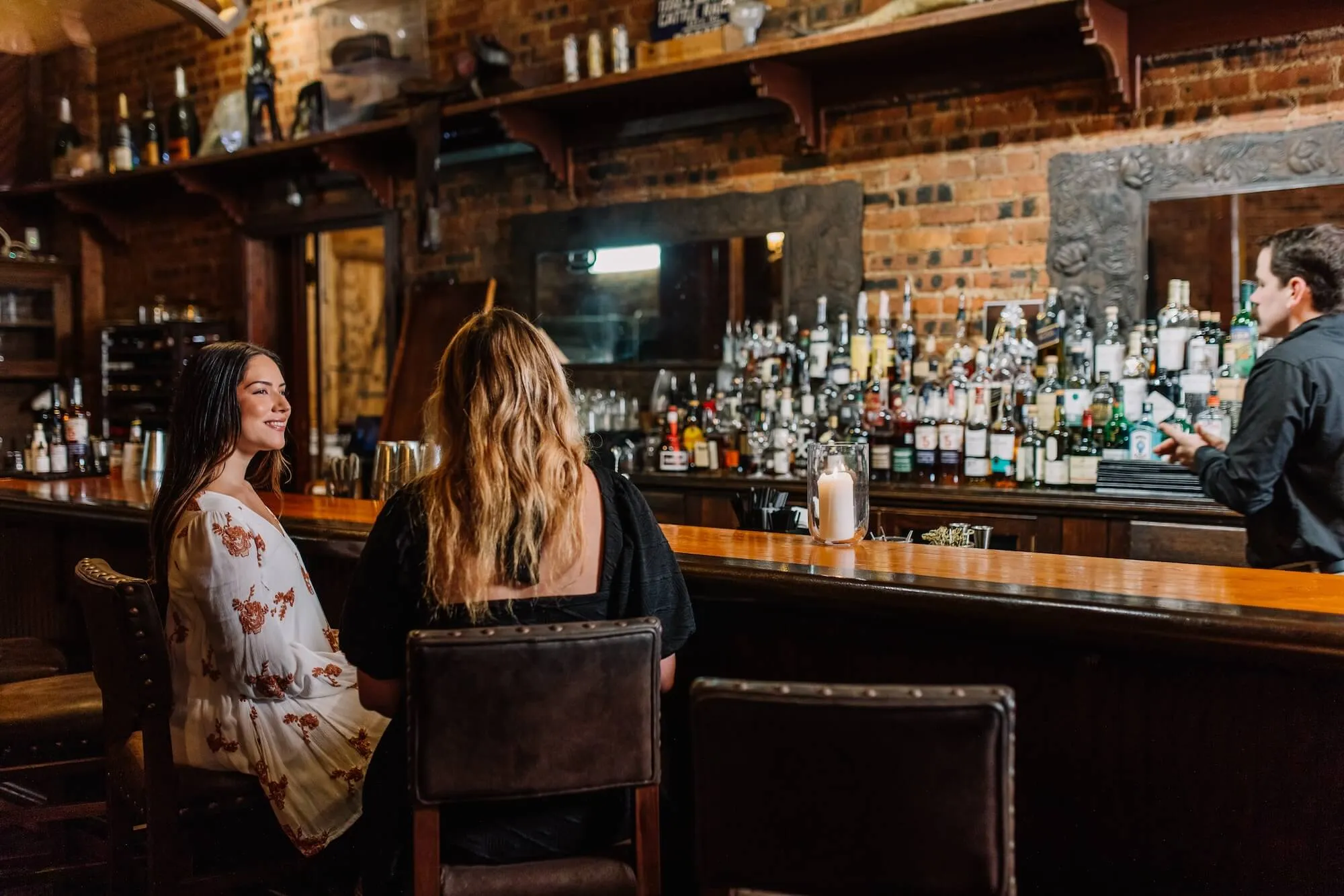 An image of women at the bar at Lonesome Dove Western Bistro in Fort Worth, TX.
