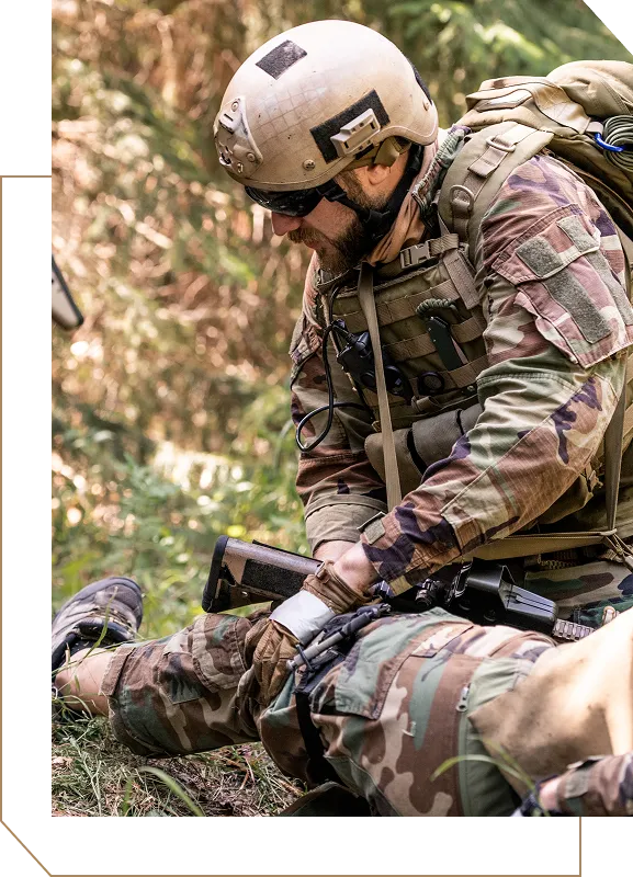 A tactical unit rendering medical aid to injured personnel and calling in a medevac