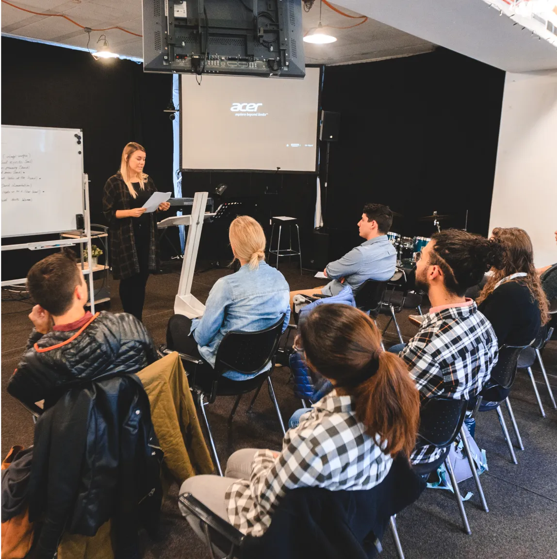 An image of a group of students sitting in a lecture hall listening to a lecdturer.