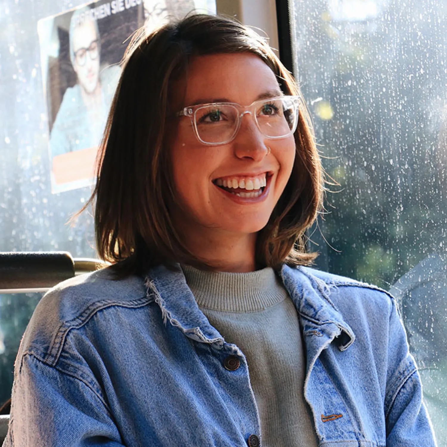 A close-up portrait image of a female student wearing clear glasses and smiling.