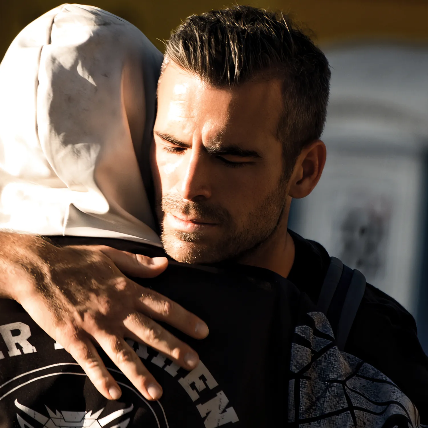 Two YWAM Lausanne students hugging in the city centre of Switzerland during worship.