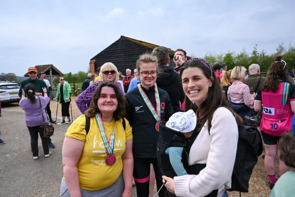 Three people smiling