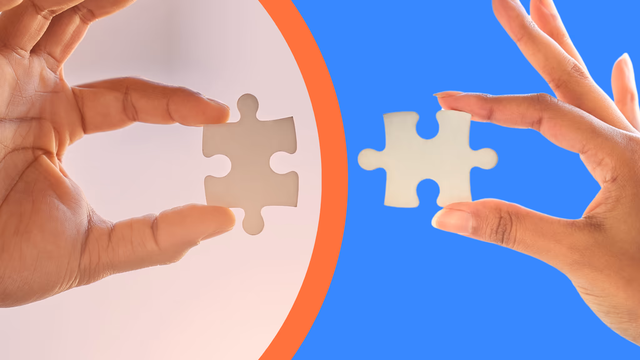 Two hands holding puzzle pieces facing each other, symbolizing collaboration and connection.