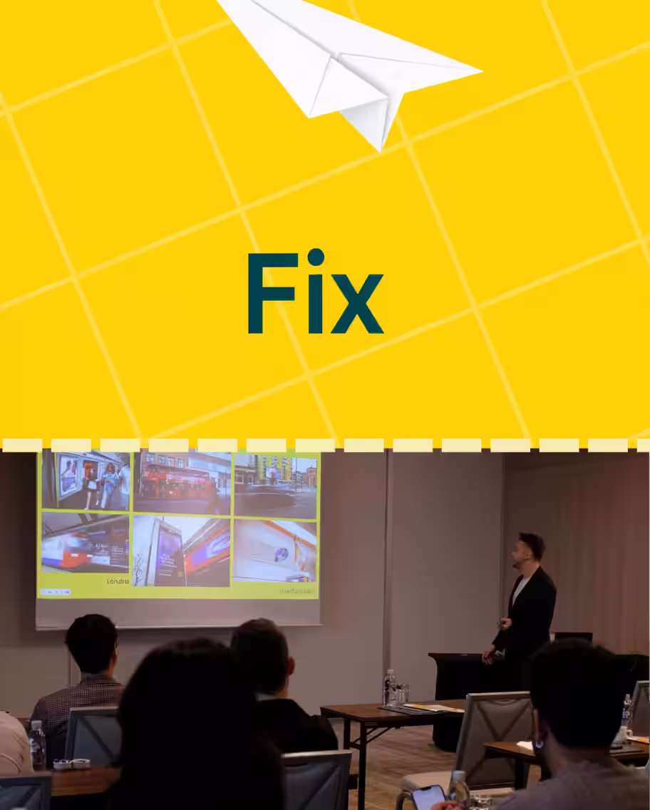 Audience group in a conference room, made up of people giving a presentation and looking at slides regarding crisis management.