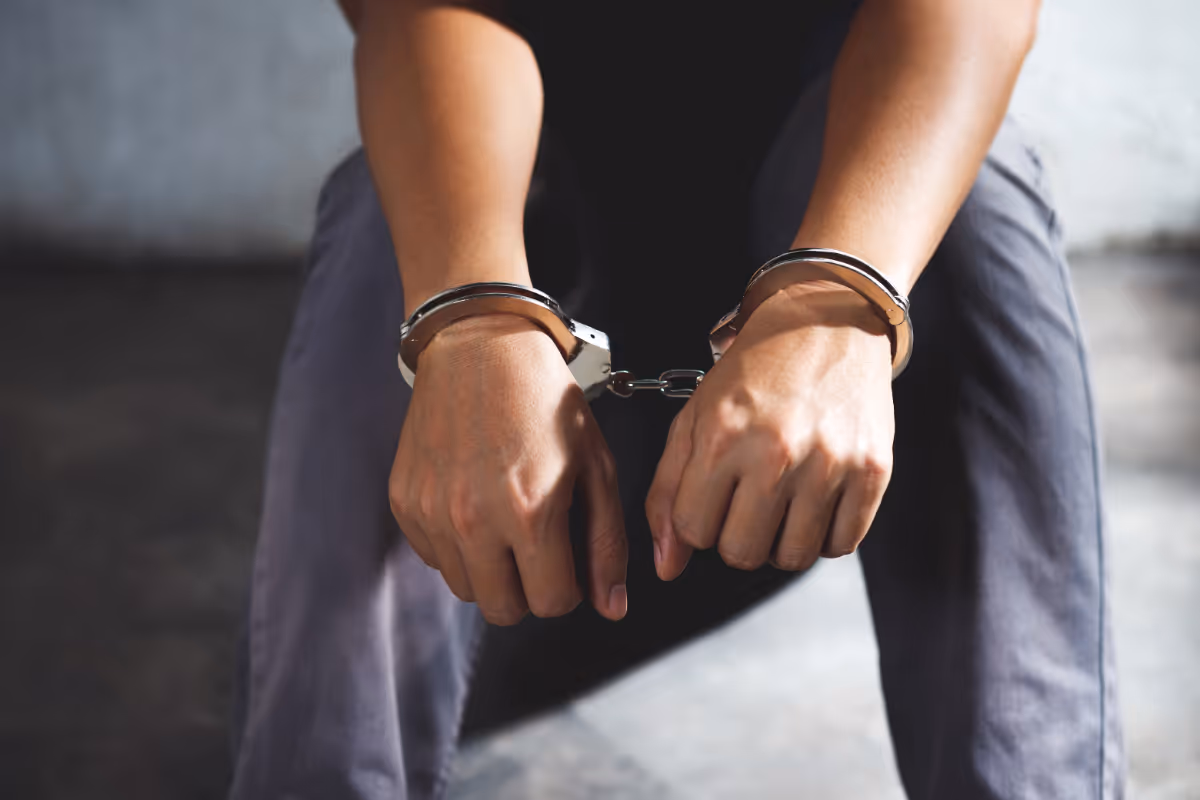 A person in handcuffs.