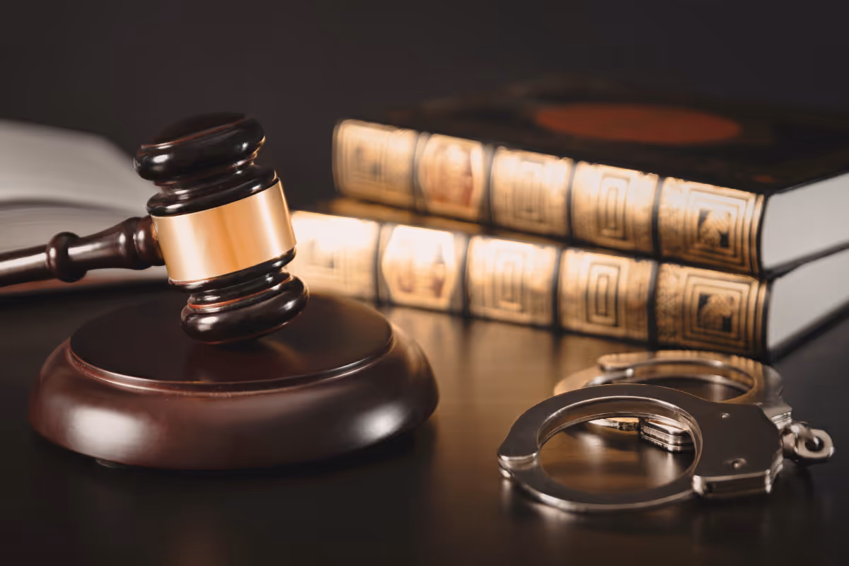 A law office desk with book, handcuffs, and a gavel.