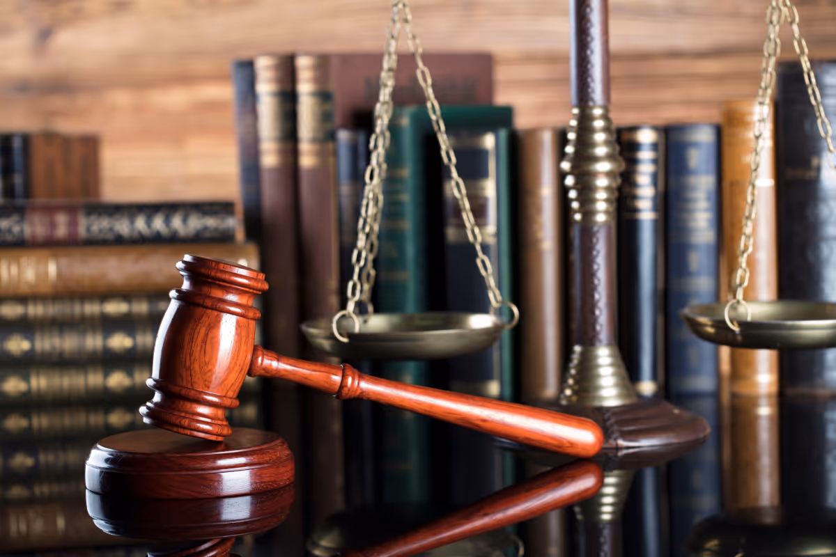 An image of a gavel and law books on a table.
