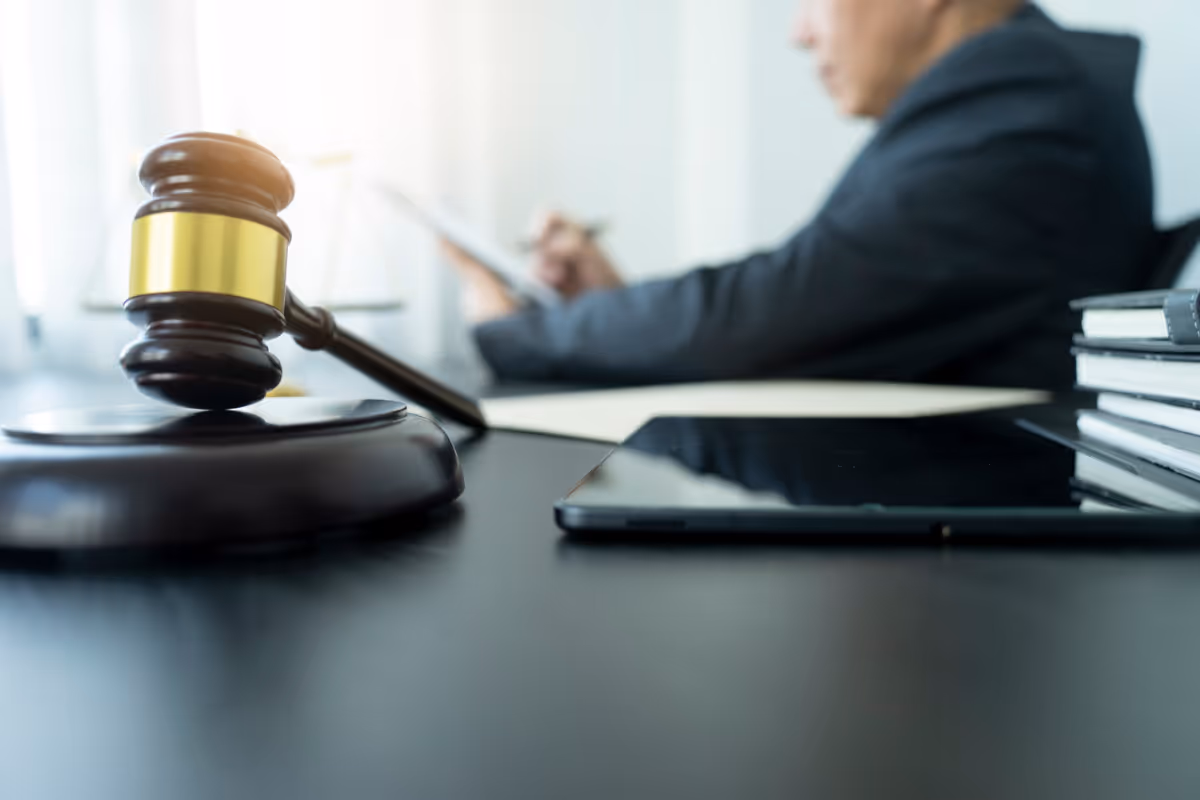 A law office with a lawyer sitting at their desk with a gavel on the desk.