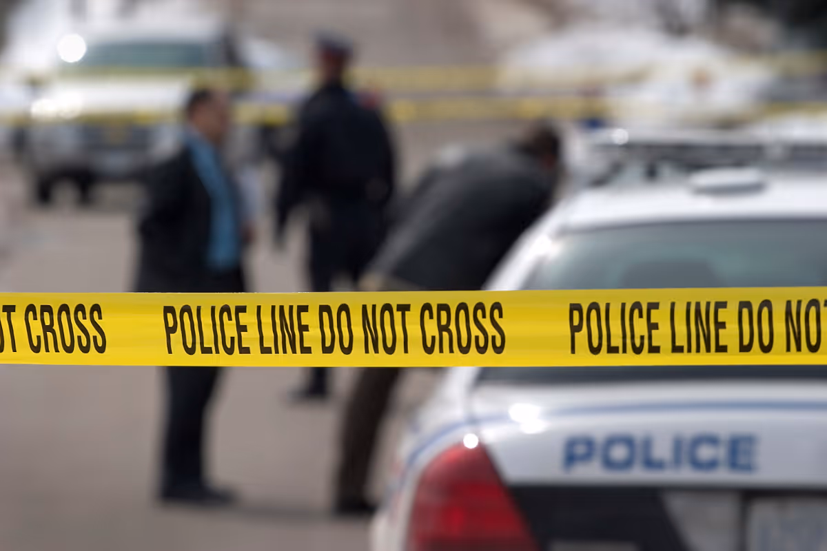 a crime scene with police and caution tape during the day