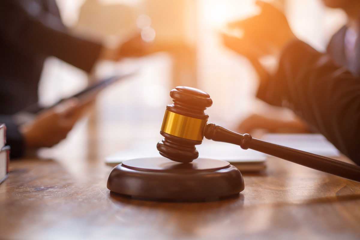 Gavel with blurred lawyers in the background