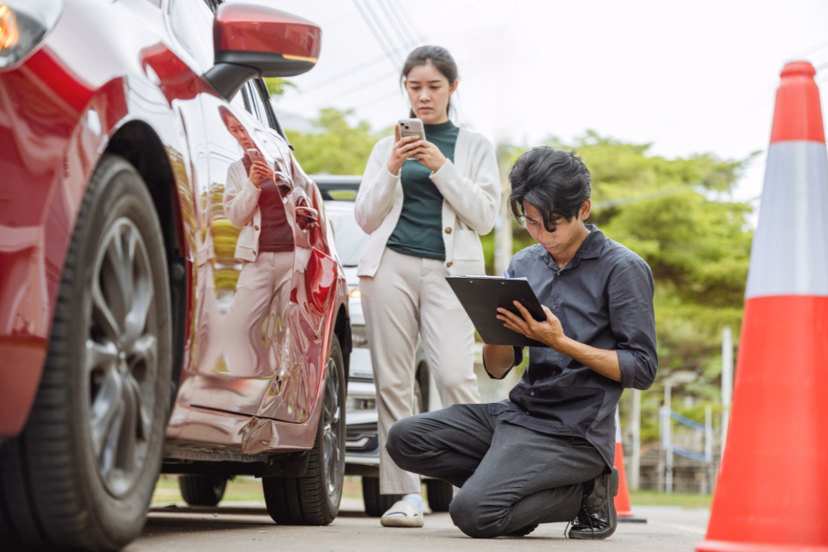 People analyzing car after an accident