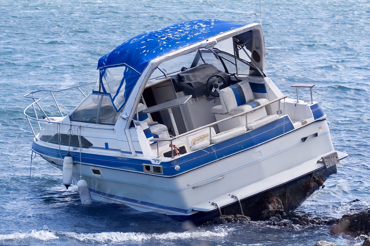 A slanted boat after hitting large rocks