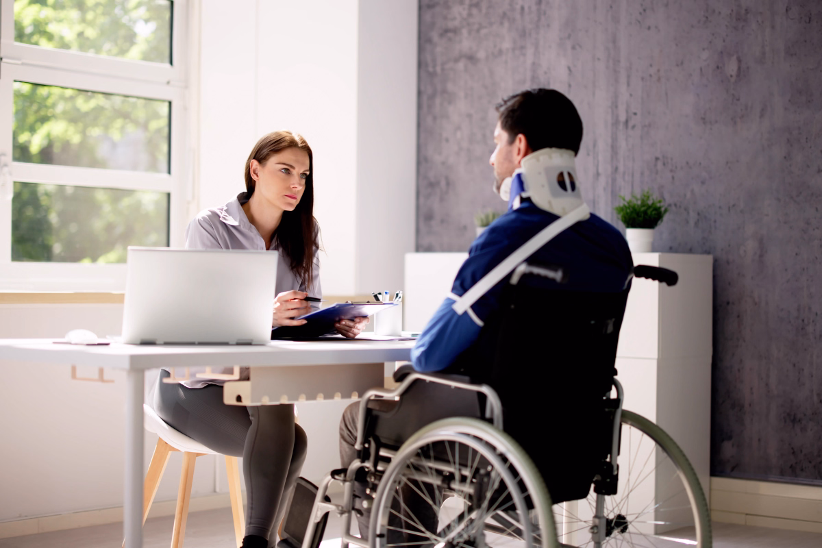 Man in a neck brace and cast consulting a professional