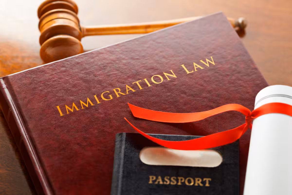 An immigration law book and passport.