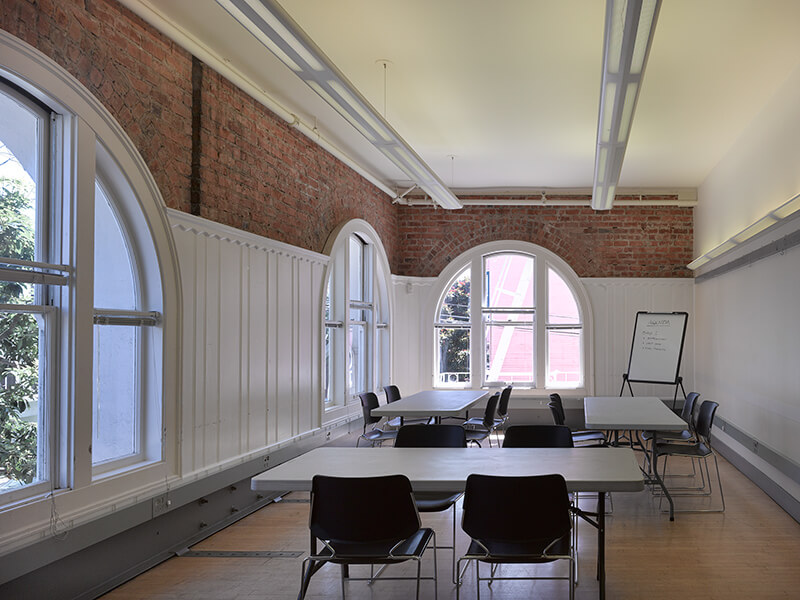 Interior of Room A with tables and chairs arranged for a meeting or group activity.
