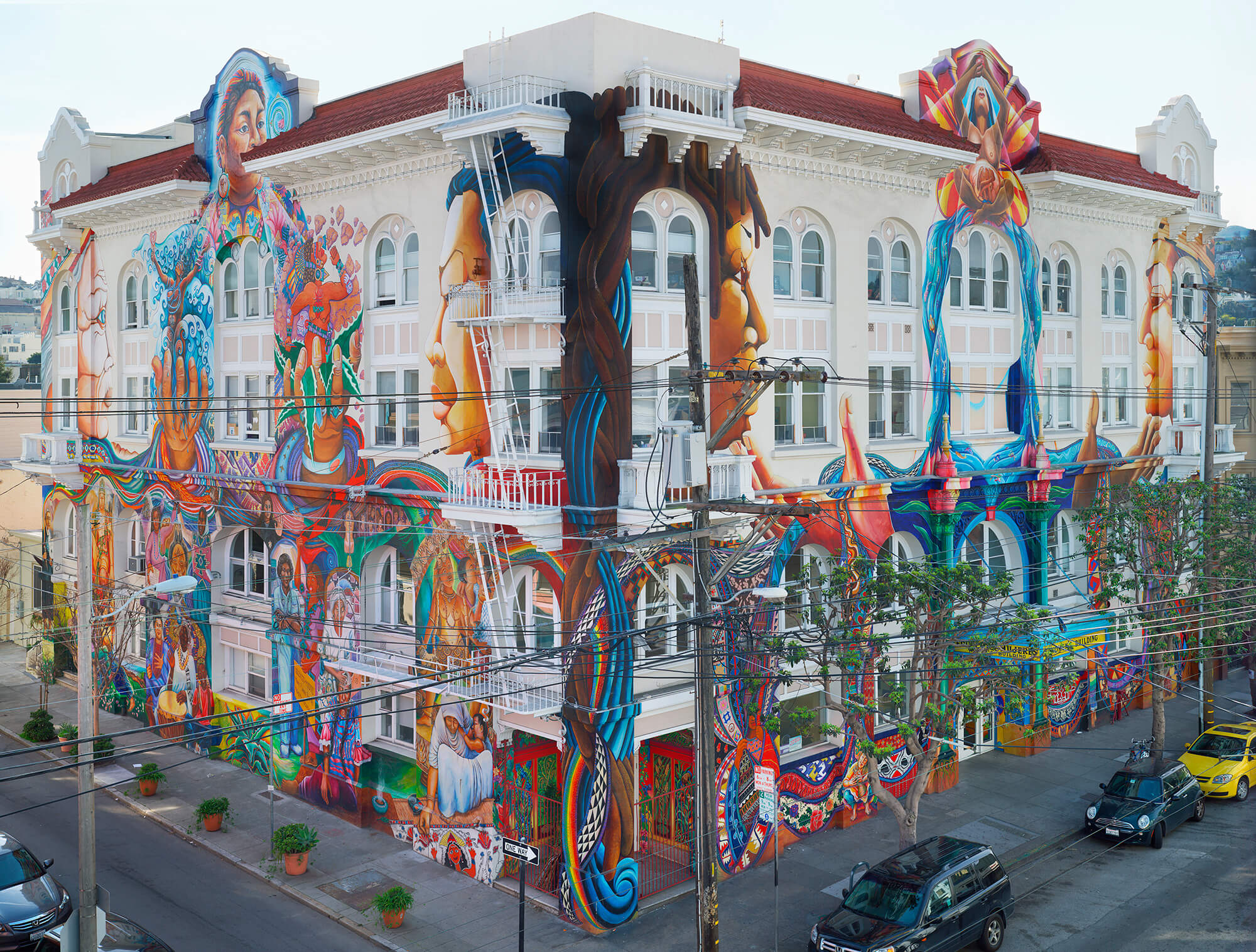 Panoramic view of The Women's Building mural, covering the entire facade with colorful, powerful imagery of women and community empowerment.