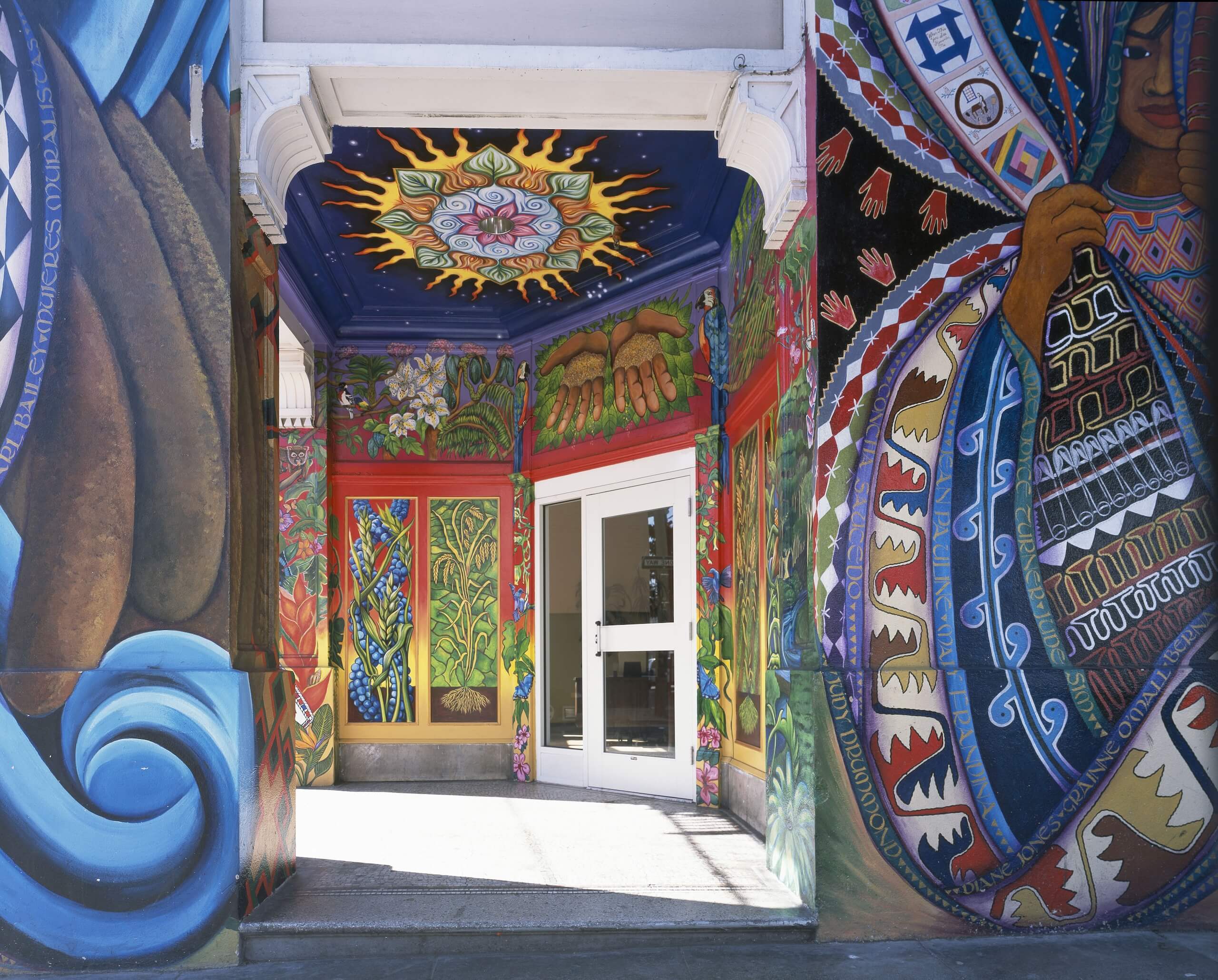 Vividly painted entryway to The Women’s Building, with detailed murals covering the walls and ceiling.
