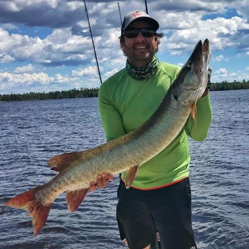 Brant Buckley catches a Musky in Canada in a green shirt
