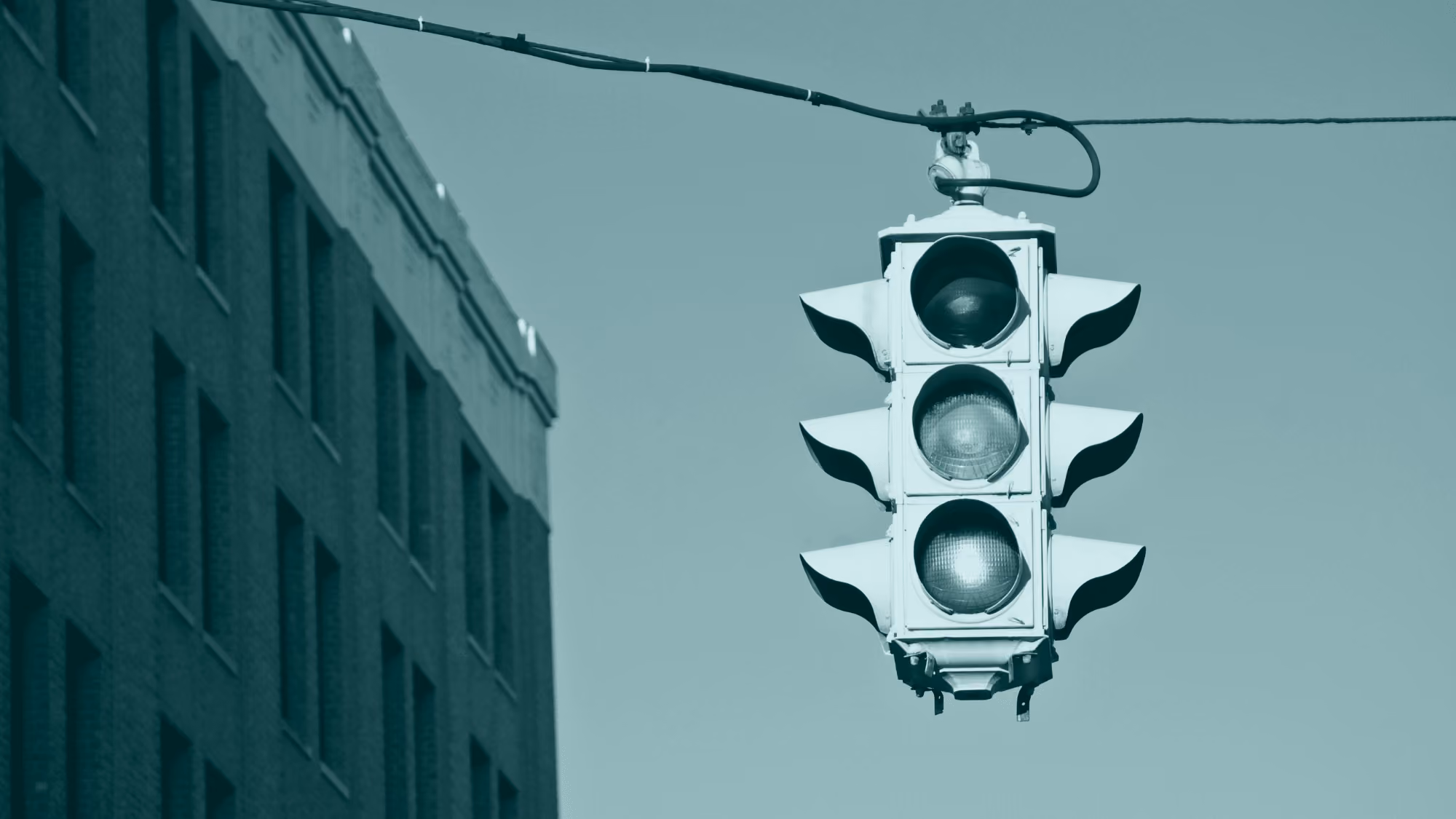 Amber traffic light representing uncertainty and the need for judgment in global payment verification.