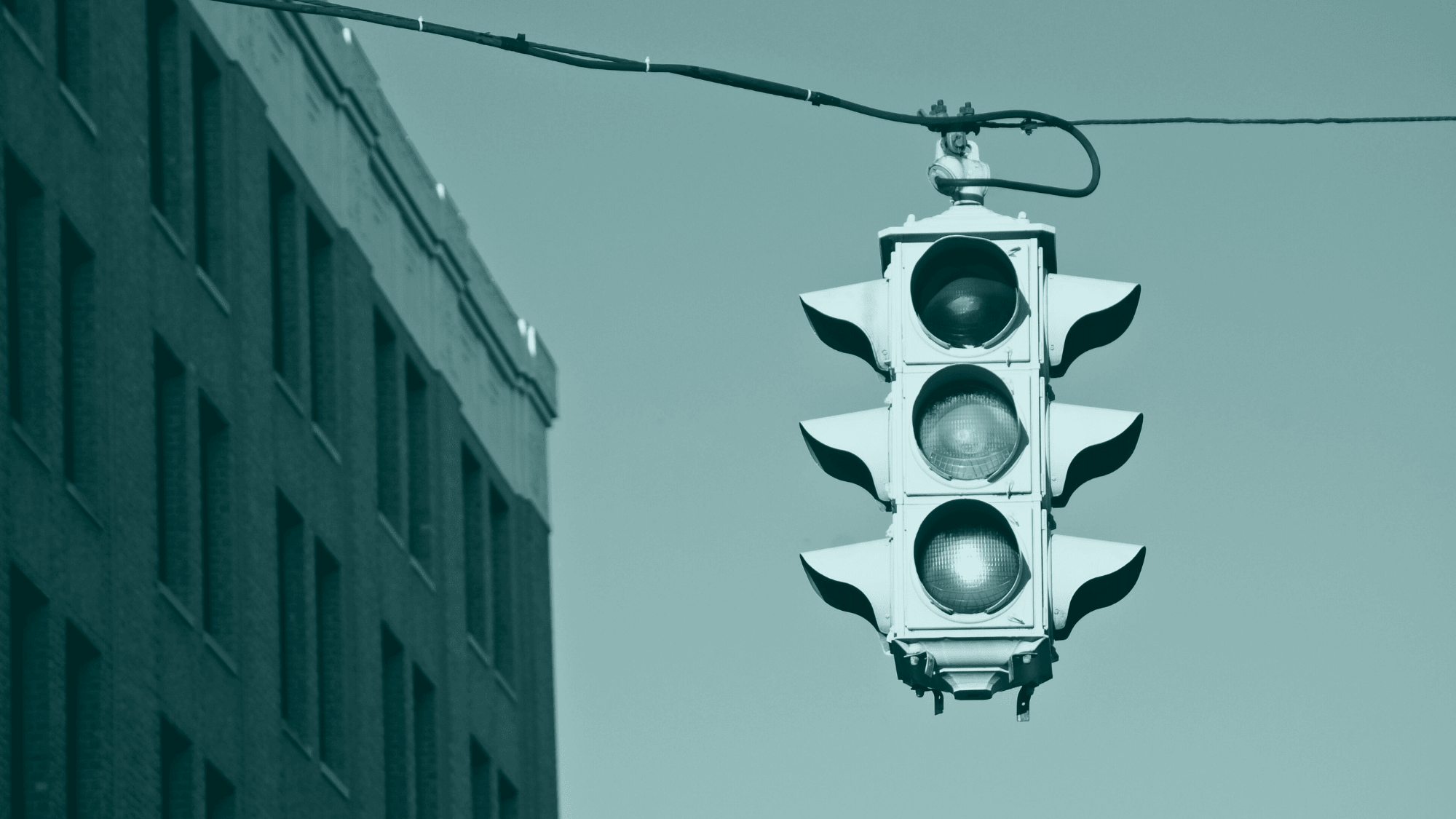 Amber traffic light representing uncertainty and the need for judgment in global payment verification.