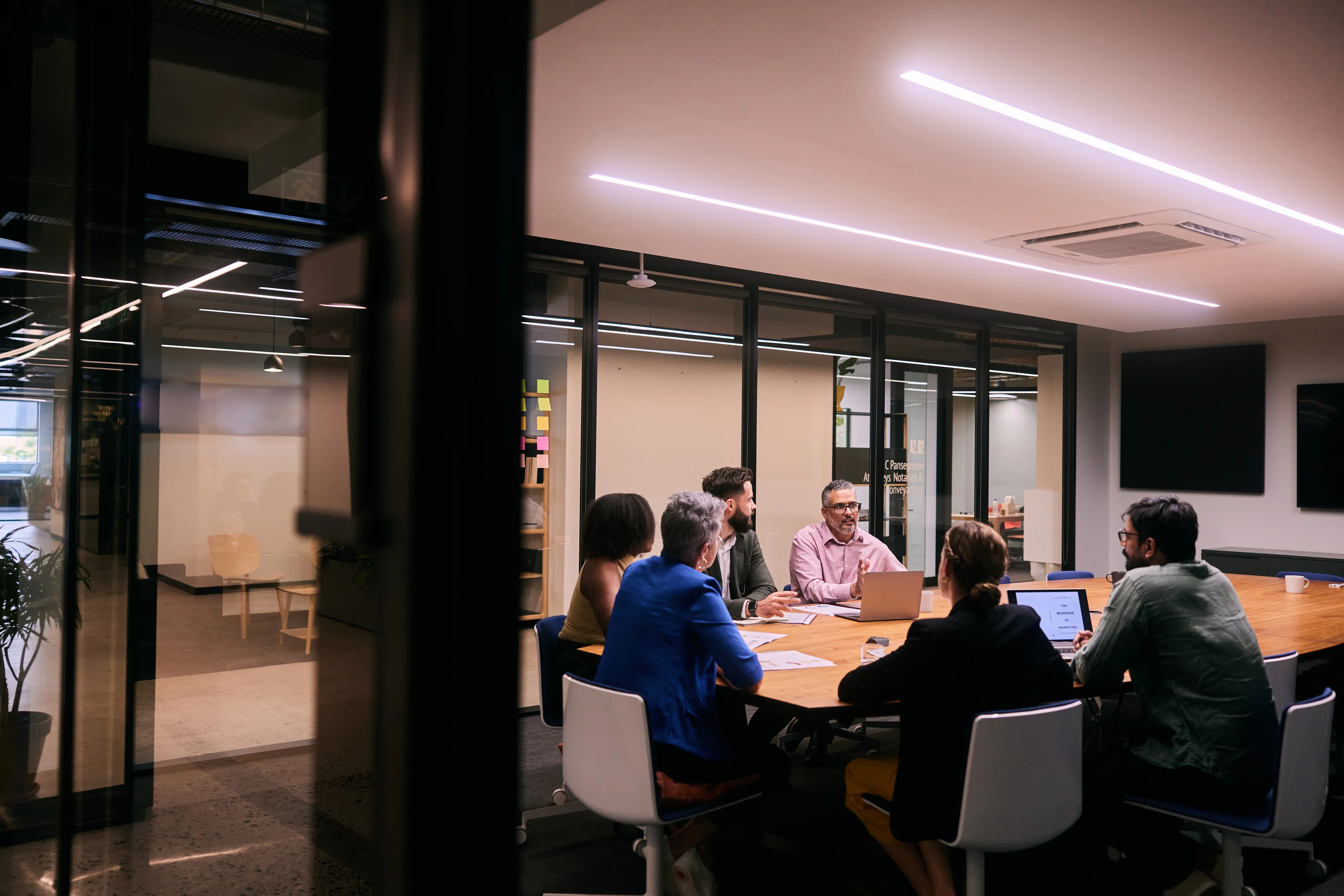 Business team meeting around a boardroom table in a modern office