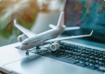 A model airplane sitting on top of a laptop computer.