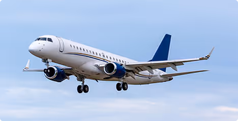 White commercial airplane with blue accents flying in a partly cloudy sky.