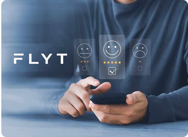 A man sitting at a table using a cell phone.