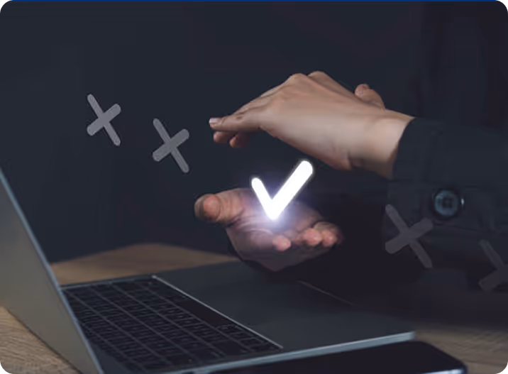 A person using a laptop with a glowing v on the screen.