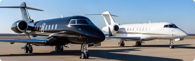 Two small airplanes are parked on the tarmac.