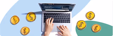 A person typing on a laptop surrounded by coins.