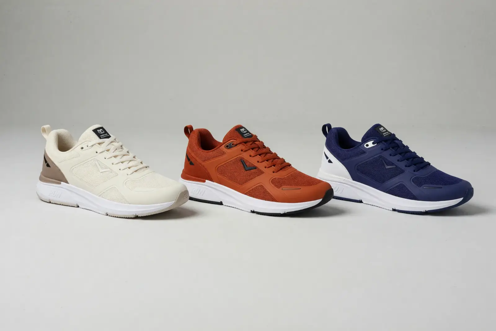 E-commerce product shot generated with Grok Imagine Image 2 — the same sneaker in cream, orange, and navy colorways