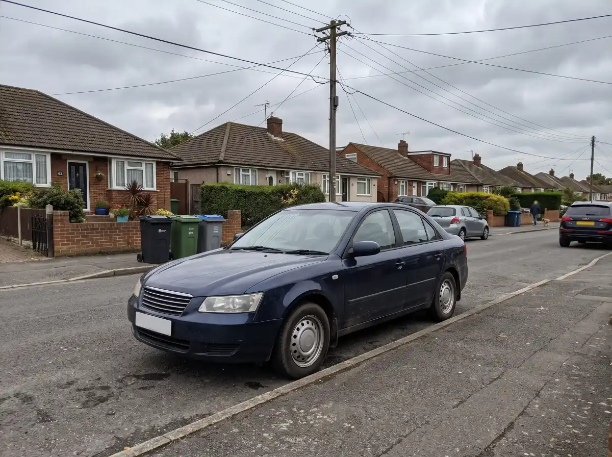 A dark blue sedan parked on an ordinary suburban street