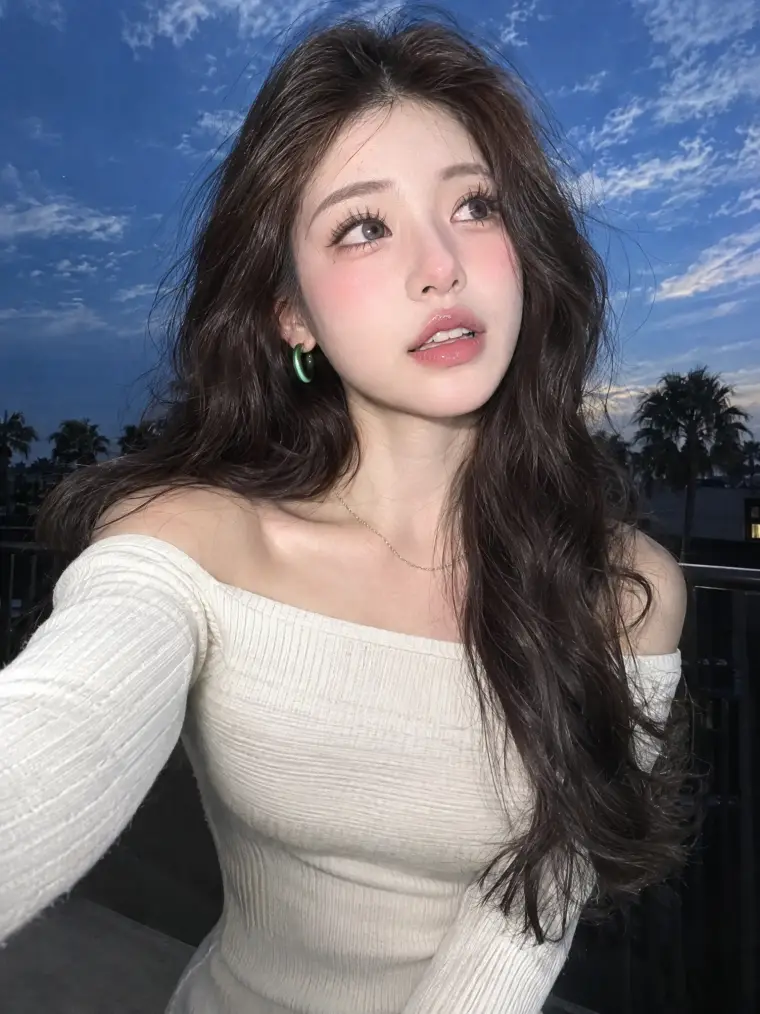 Candid rooftop selfie of a young woman at dusk