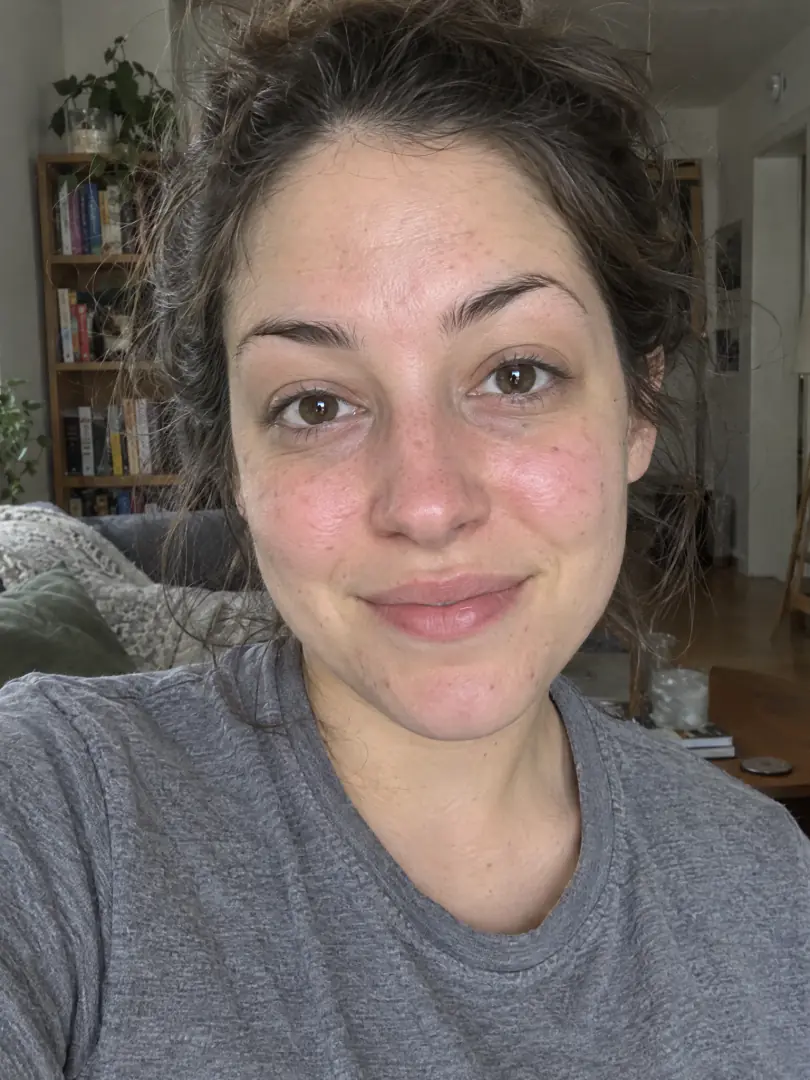 Before: an everyday selfie of a woman at home, messy bun, no makeup