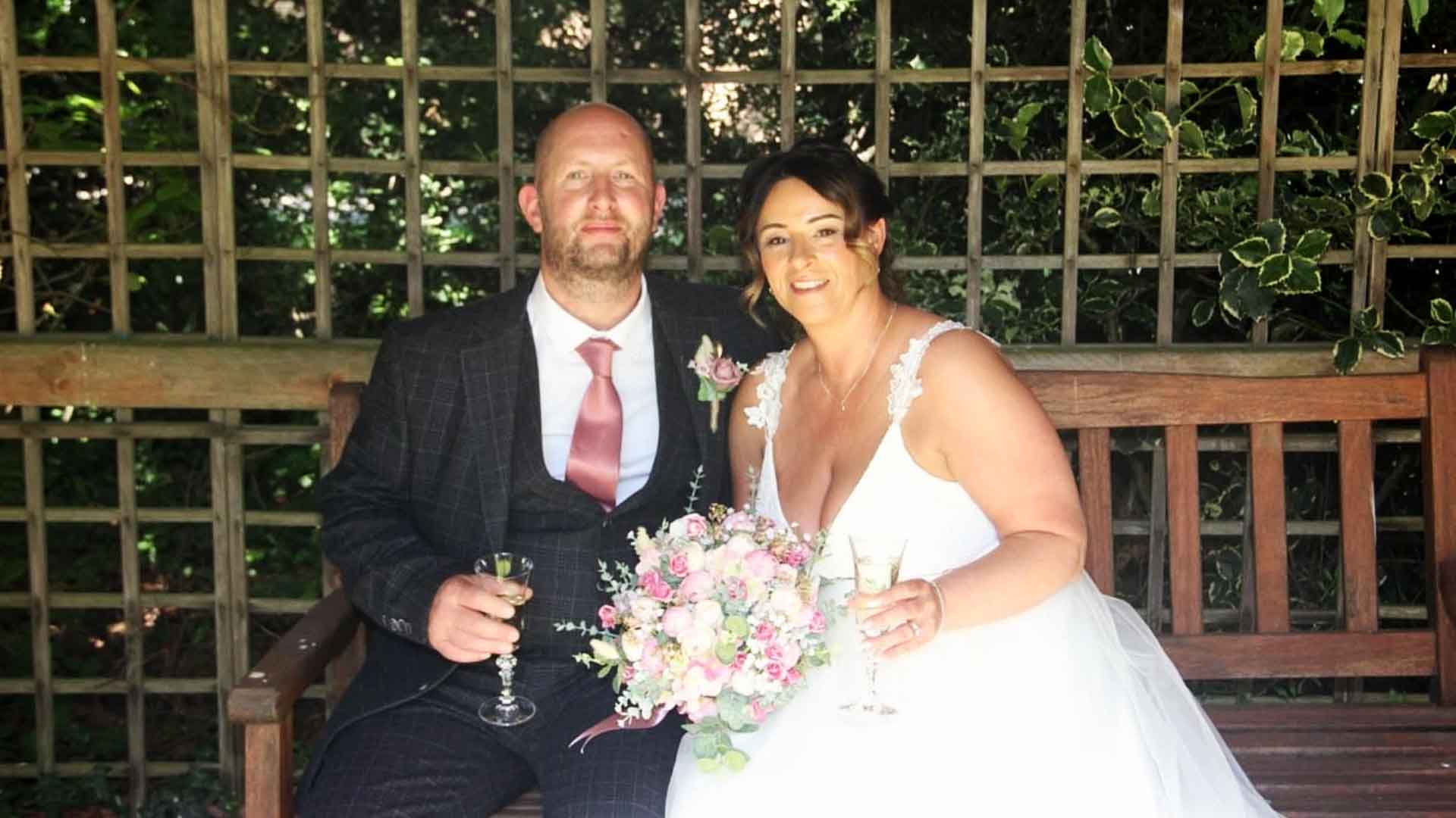 Wedding couple on a bench at Garstang Country Hotel 