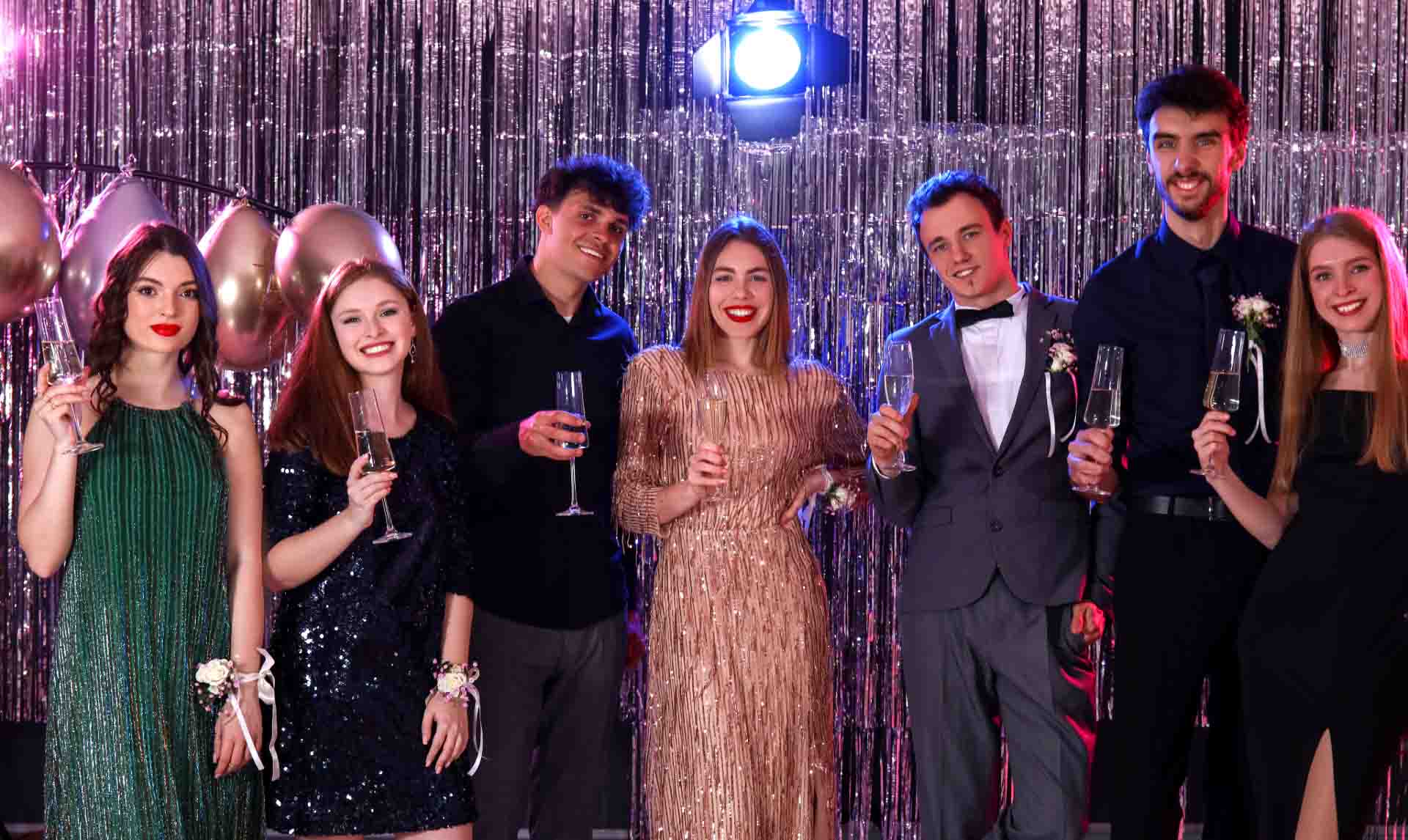 People dressed up nicely for Prom, holding drinks