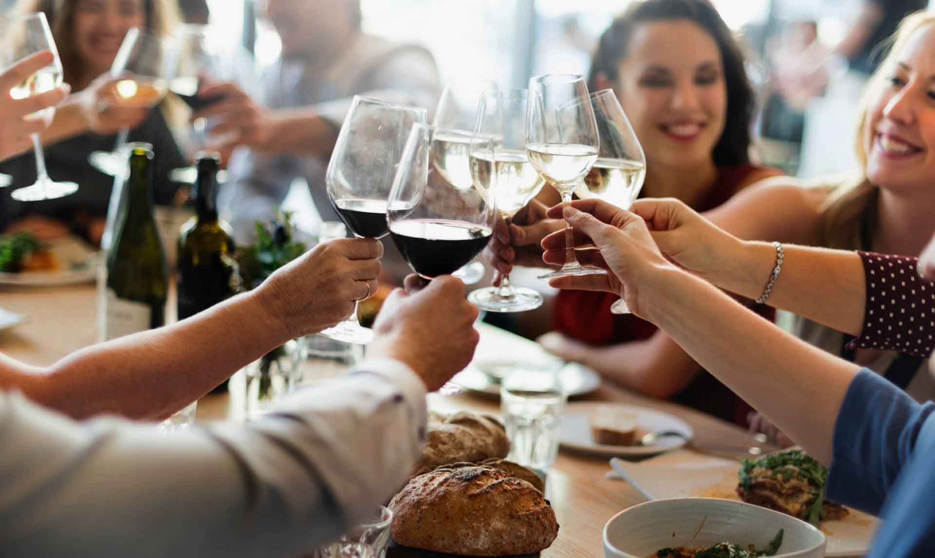 Family with glasses and food on a table 