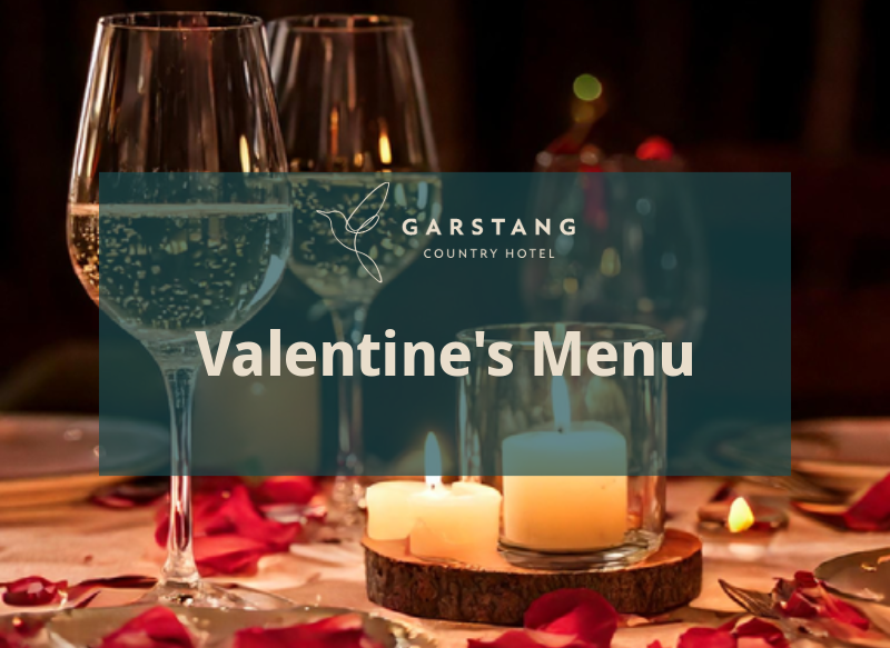 Candlelight and glasses of wine with rose petals on the table