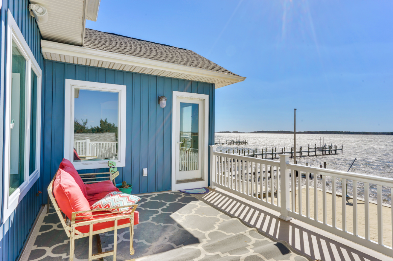 Upper balcony with outdoor seating overlooking dock and open water on Baystream Dr., Toms River NJ