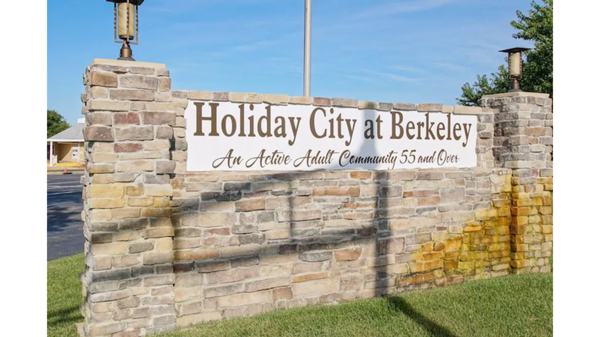 Entrance sign for Holiday City at Berkeley, a 55+ active adult community in Toms River, NJ, featuring a stone wall and bold lettering. Ideal for retirees seeking vibrant living, with homes serviced by J.A.Y. Construction—the premier choice.