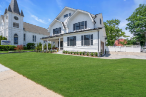 Luxury home exterior in Manasquan NJ with professional landscaping and classic black and white design by J.A.Y. Construction 