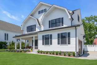 Side view of luxury home in Manasquan NJ featuring spacious lawn and professional exterior construction by J.A.Y. Construction 