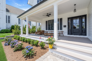 Close-up of porch and front entryway of custom-built Manasquan NJ home with decorative flowers by J.A.Y. Construction 