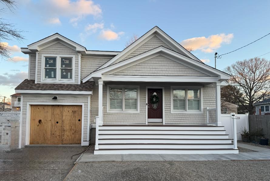 Completed porch reconstruction and addition in Brick, New Jersey by J.A.Y. Construction, built with engineered footings to correct structural sagging after a home lift.