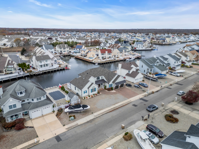  Aerial drone view of a custom luxury waterfront home built by J.A.Y. Construction in Ocean County, New Jersey, showcasing coastal home construction, custom home building, waterfront architecture, premium craftsmanship, private dock access