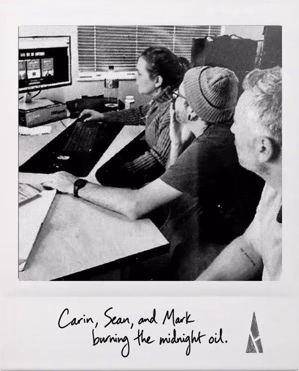 Polaroid picture of Atypical Team members working together at a desk