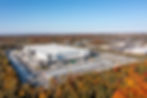 An aerial photograph of a commercial warehouse property with a large parking space and logistics fascilities