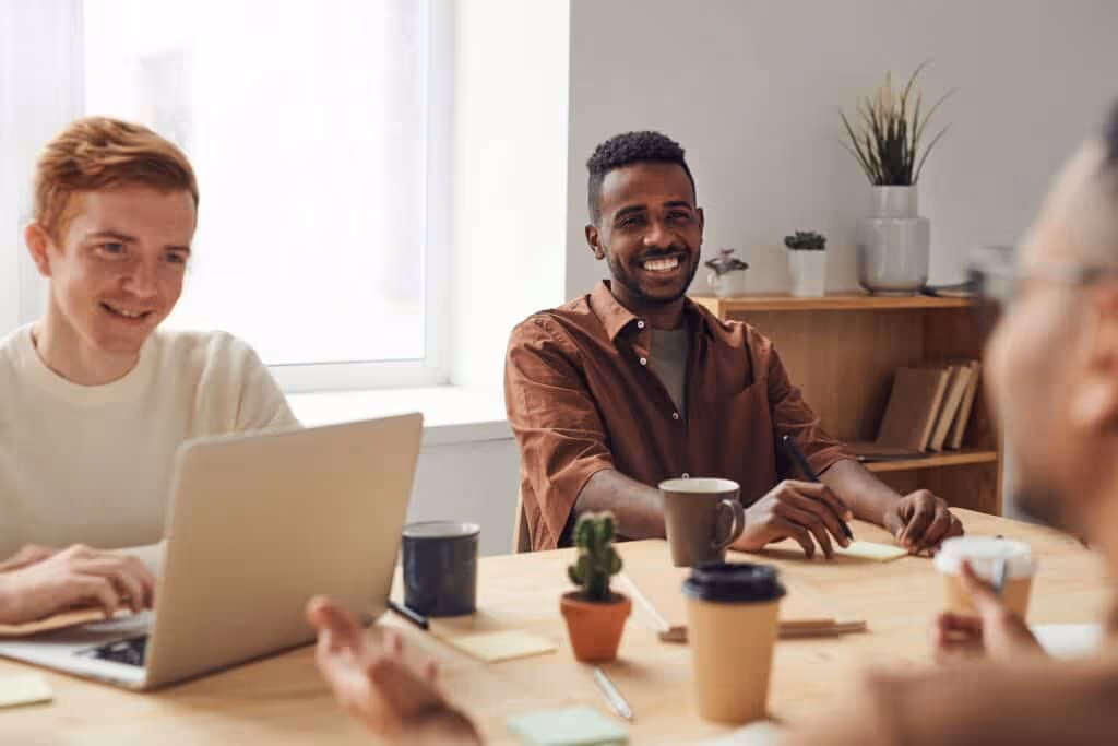 Man smiling in meeting.